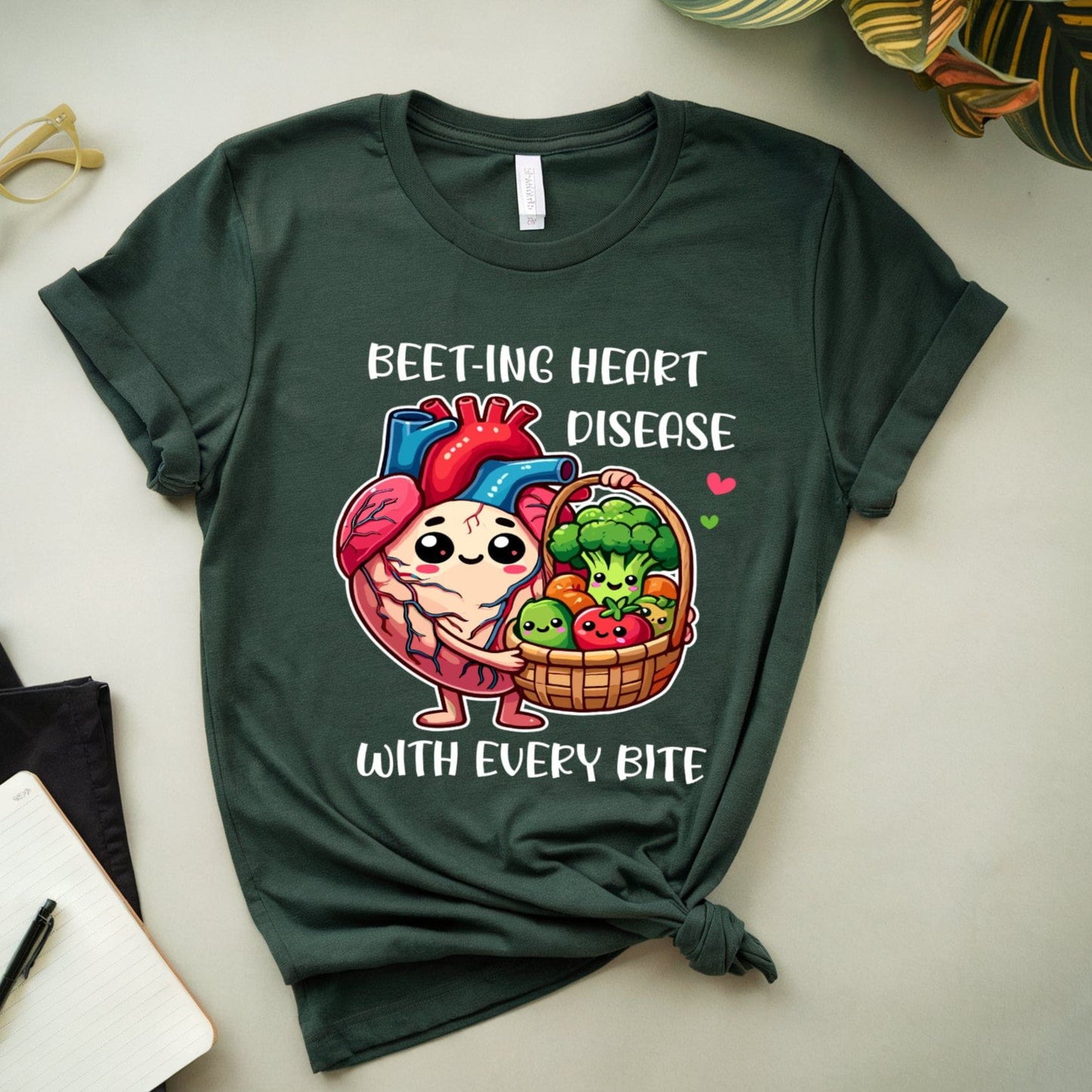 Green t-shirt with a heart and vegetables graphic and text on a light surface.