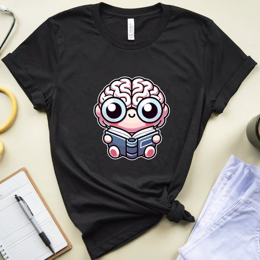 Black t-shirt with a cartoon brain design on a light surface with a stethoscope, notebook, and coffee cup.