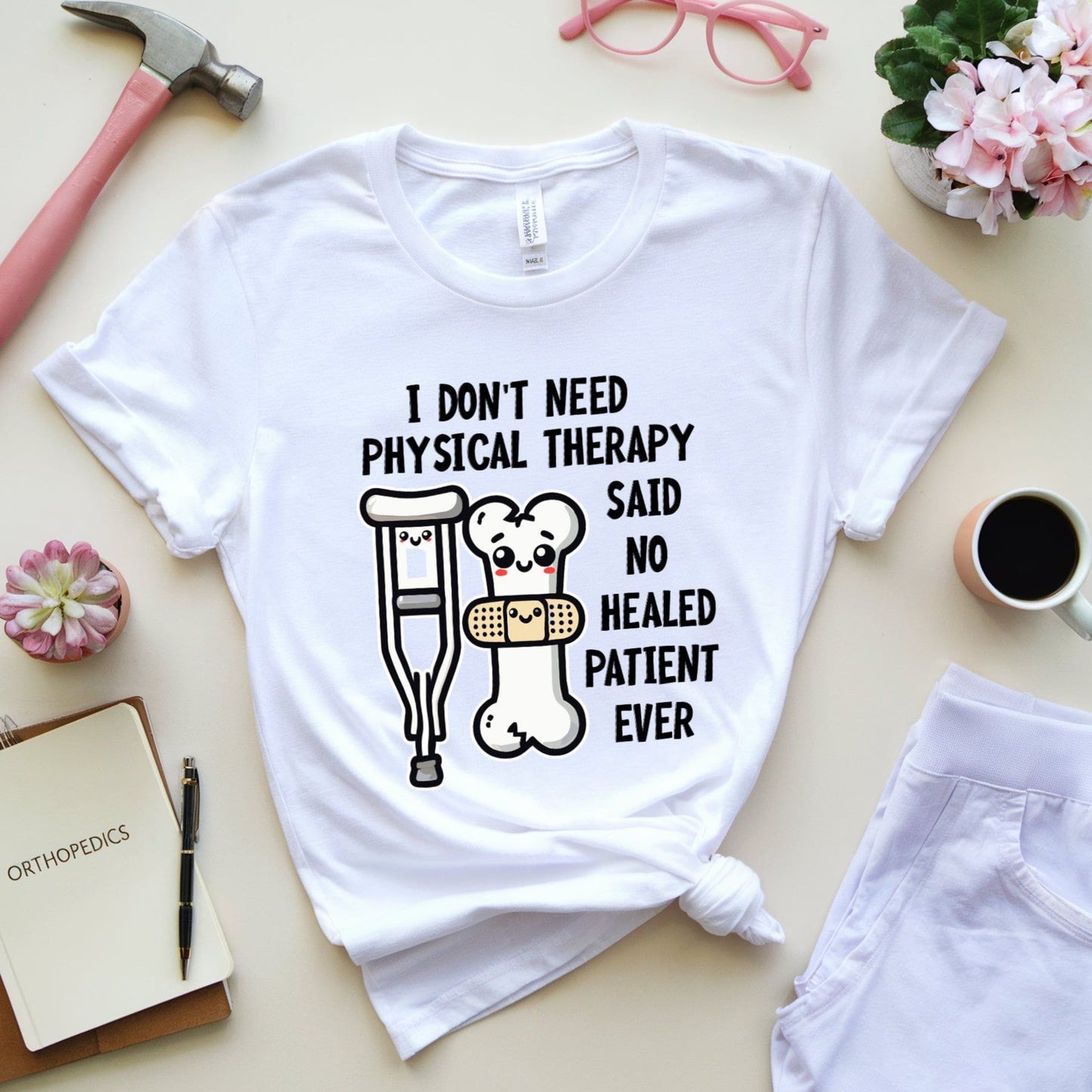 White t-shirt for orthopedics with humorous text and graphics on a table with accessories