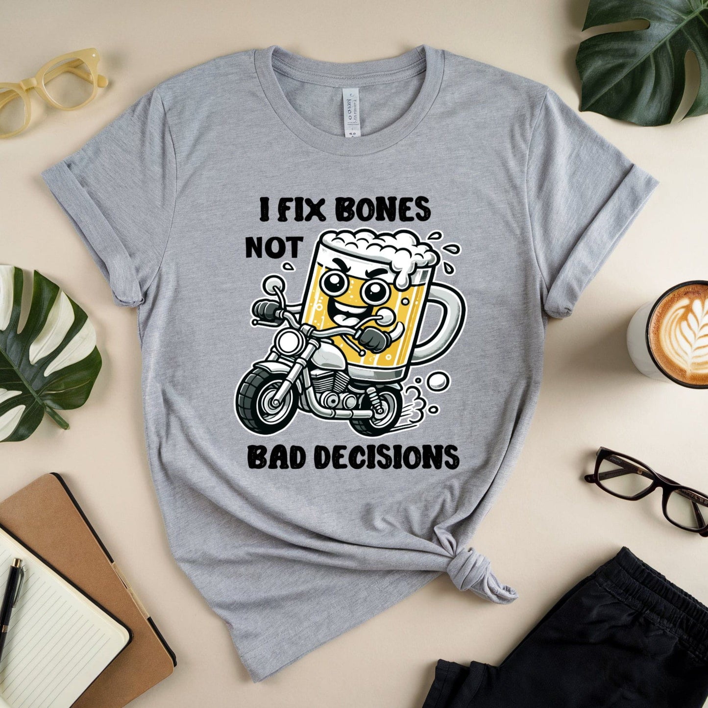 Gray t-shirt for orthopedics with a graphic design and text on a table with accessories