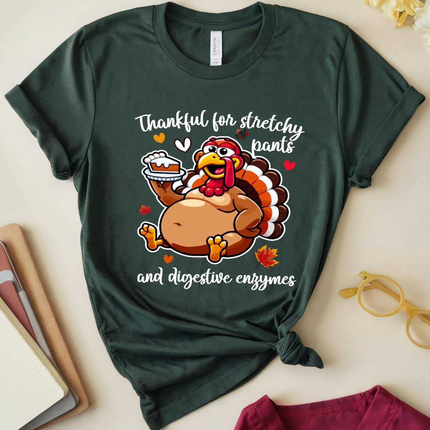 Green t-shirt with a turkey graphic Thanksgiving dinner with the words "thankful for stretchy pants ad digestive enzymes"