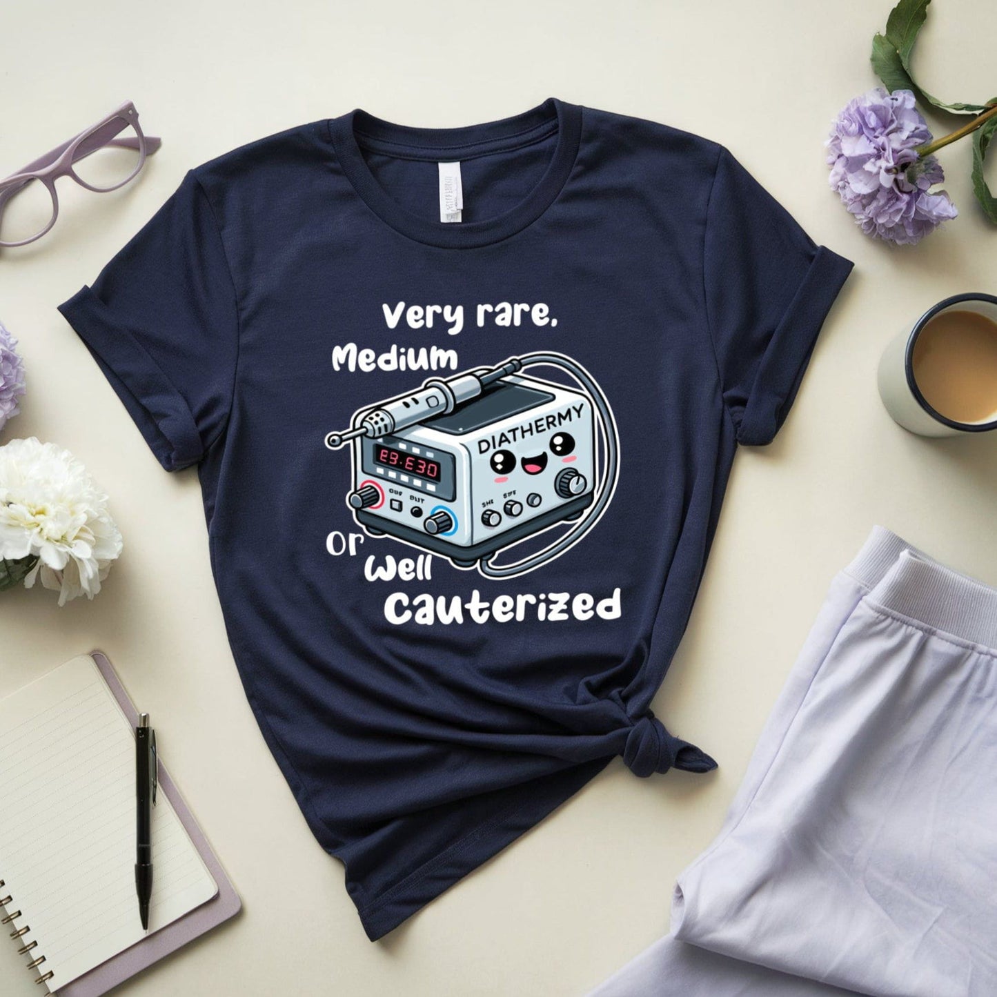 Navy blue t-shirt for surgeons with graphic design and text on a light surface with accessories.