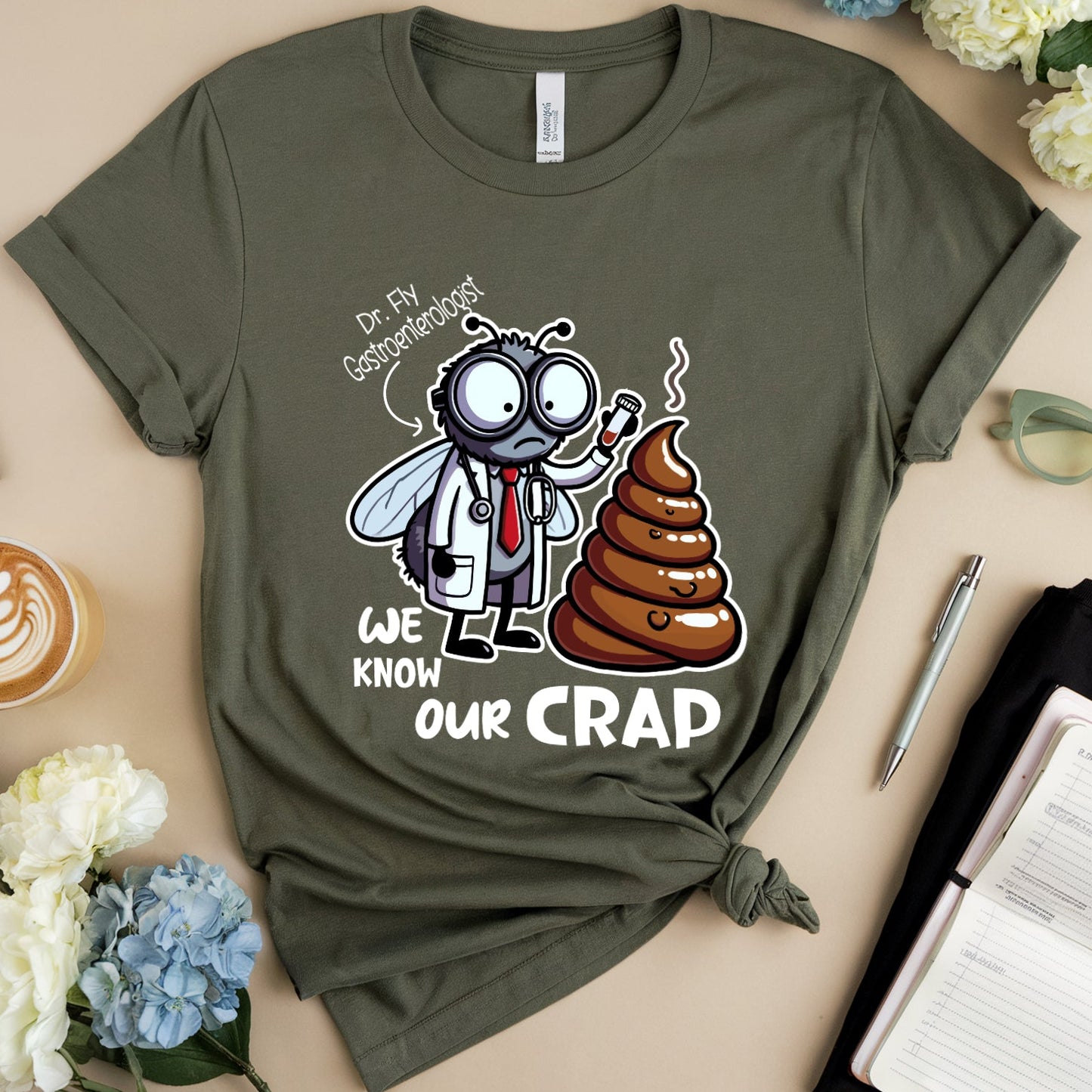 Green t-shirt with cartoon a funny graphic design of a dr fly a gastroenterologist holding a test tube near a huge pile of poop.