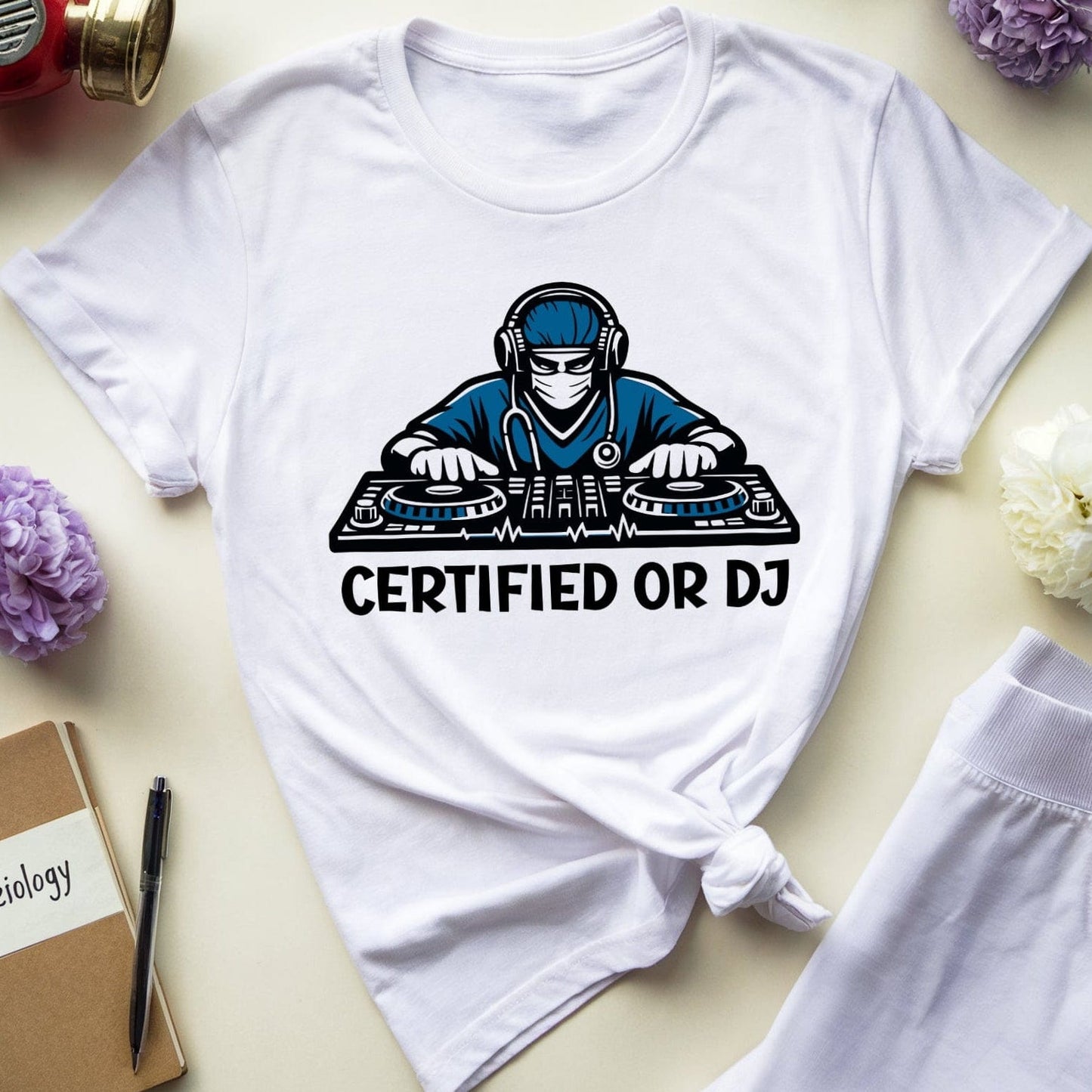 White t-shirt with 'Certified or DJ' graphic on a light surface with accessories.