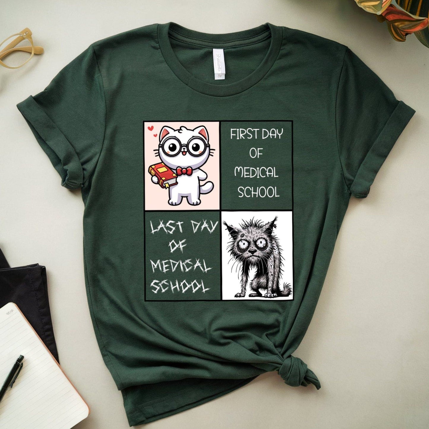 Green t-shirt with cartoon cat illustrations and text on a white surface