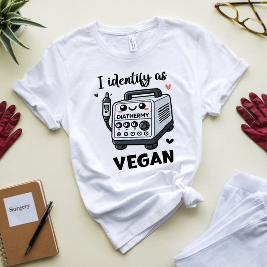 Funny white  t-shirt for surgeons with a graphic and text on a light surface with gloves and a notebook.