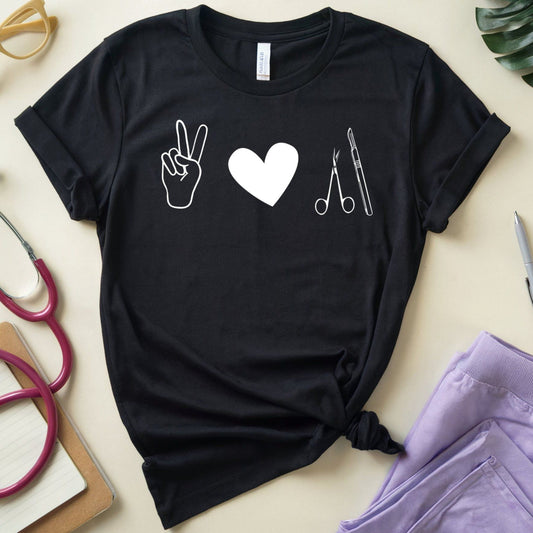 Black t-shirt for surgeons with white icons on a light surface with medical-themed items