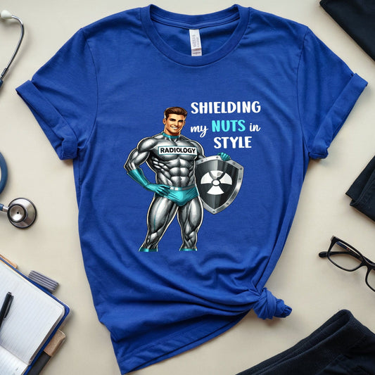 Blue t-shirt with a graphic design and text on a light surface with medical-themed items.