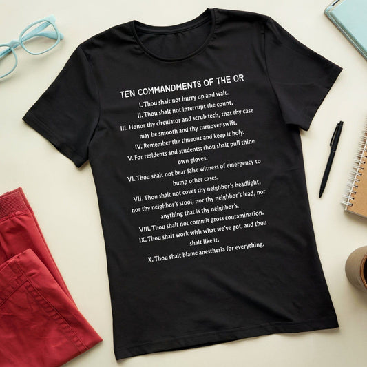 Black t-shirt with 'Ten Commandments of the OR' text on a light surface with accessories.