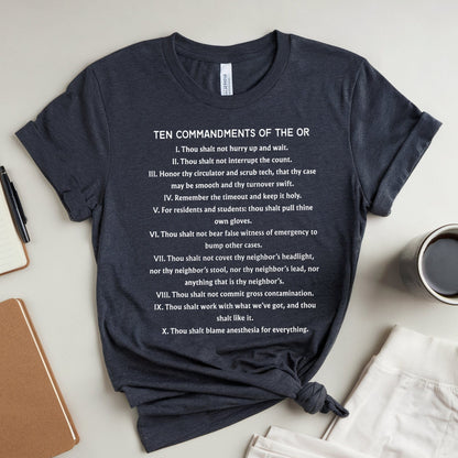 Navy blue t-shirt with text on a light gray surface with stationery items.