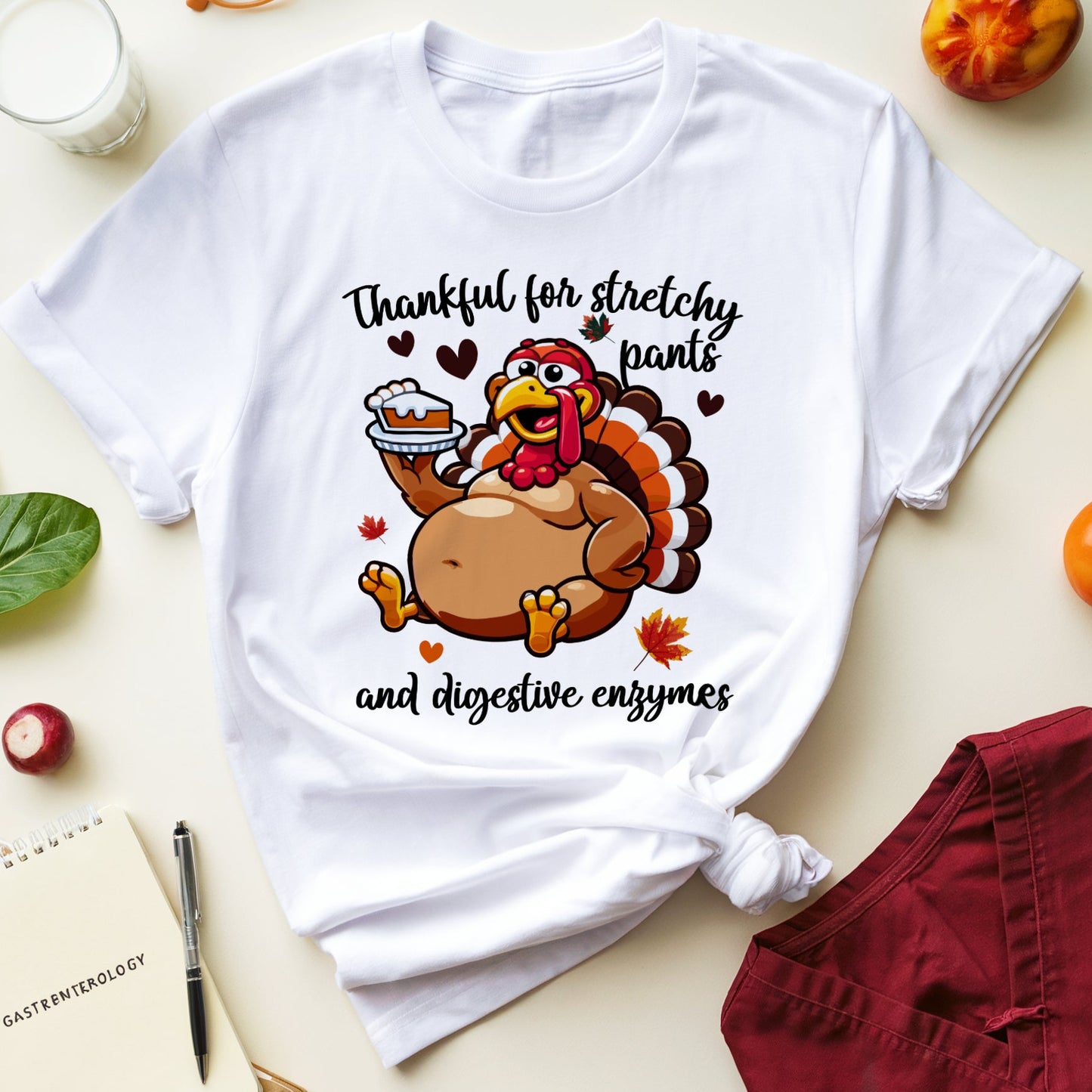White t-shirt with a turkey graphic for Thanksgiving dinner with the words "thankful for stretchy pants ad digestive enzymes"