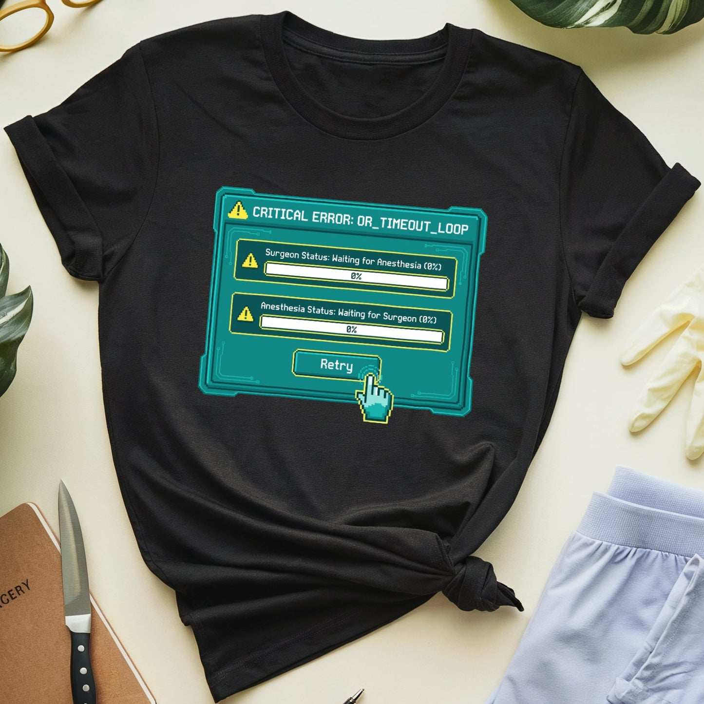 Black t-shirt with a teal graphic design on a light surface with gardening tools and plants.