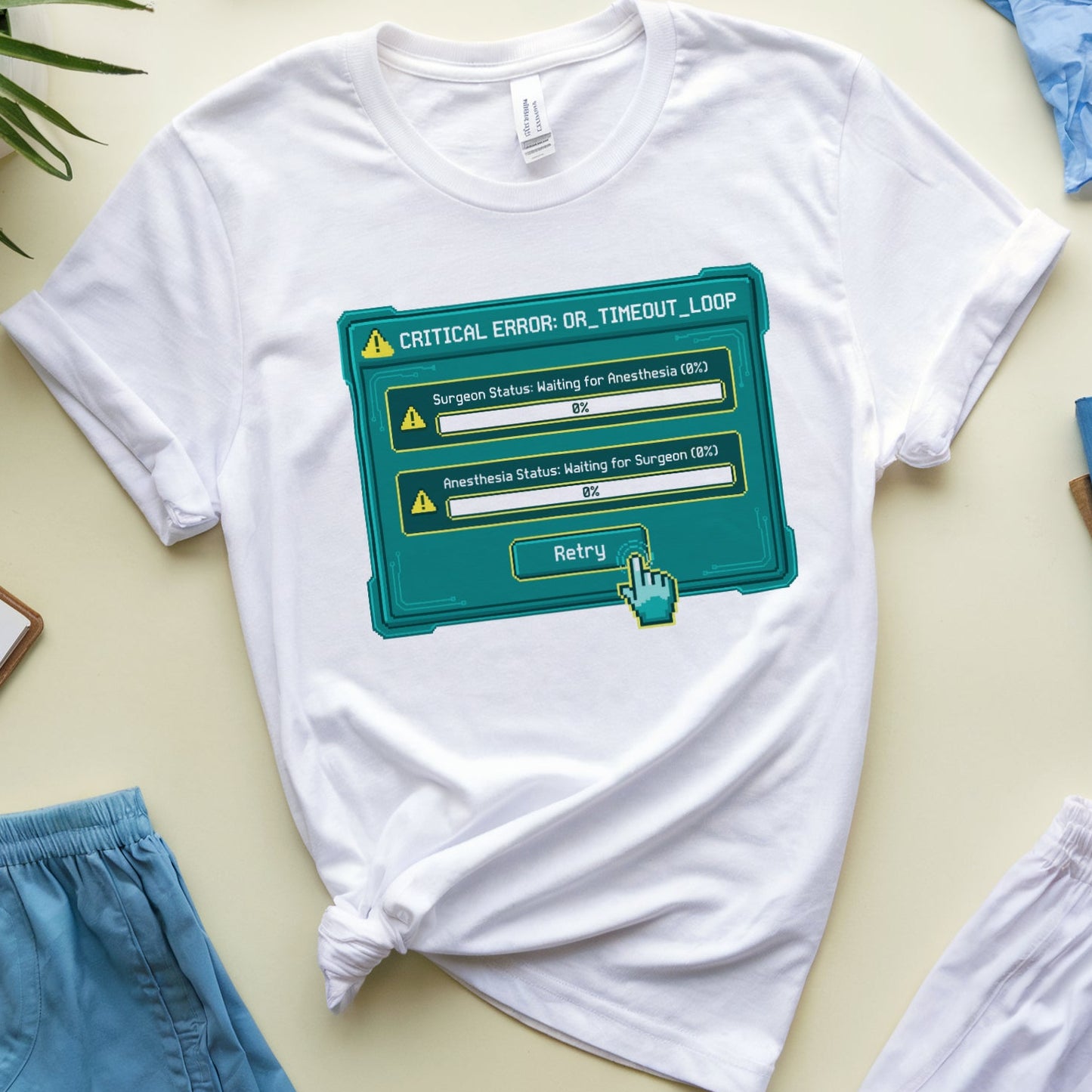 White t-shirt with a graphic design on a light surface with accessories around