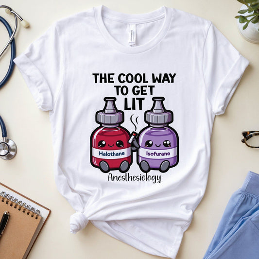 White t-shirt with cartoon anesthesia drugs design on a light surface with medical-themed items.