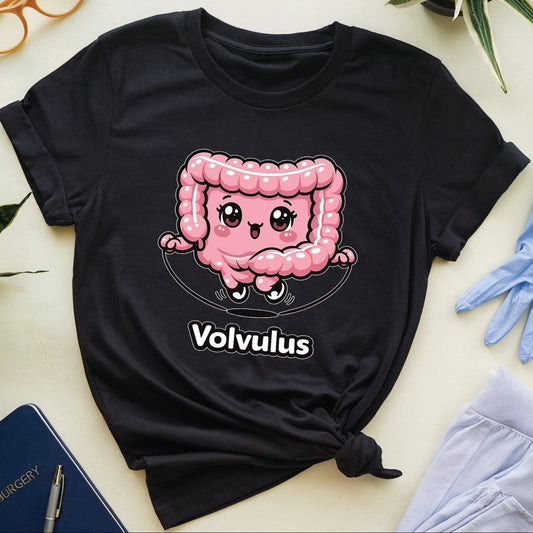 Black t-shirt with a pink cartoon character and 'Volvulus' text, surrounded by glasses, gloves, and a notebook on a light surface.