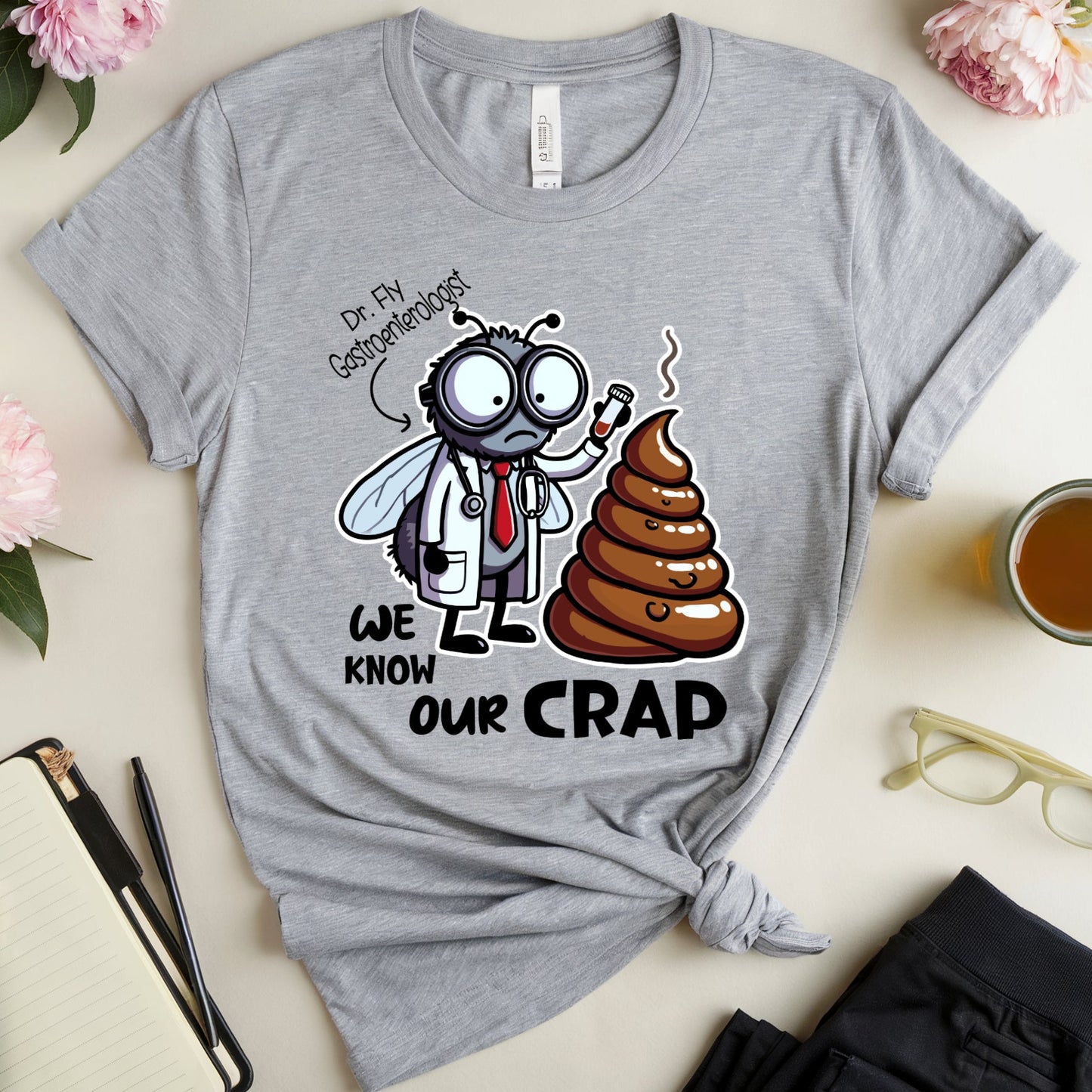 Gray t-shirt with a funny graphic design of a dr fly a gastroenterologist holding a test tube near a huge pile of poop.